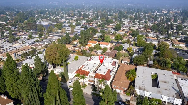 an aerial view of residential houses with outdoor space