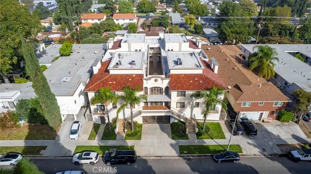 an aerial view of multiple houses with a yard