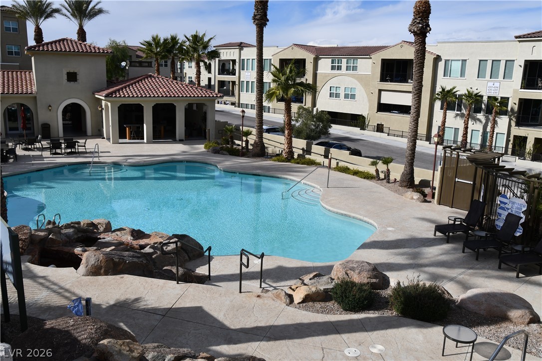 2555 Hampton Road, Unit 7109 Henderson, NV 89052 - Photo 9 of 34 A tranquil oasis featuring a resort-style pool with a clubhouse, perfect for leisure and gatherings.