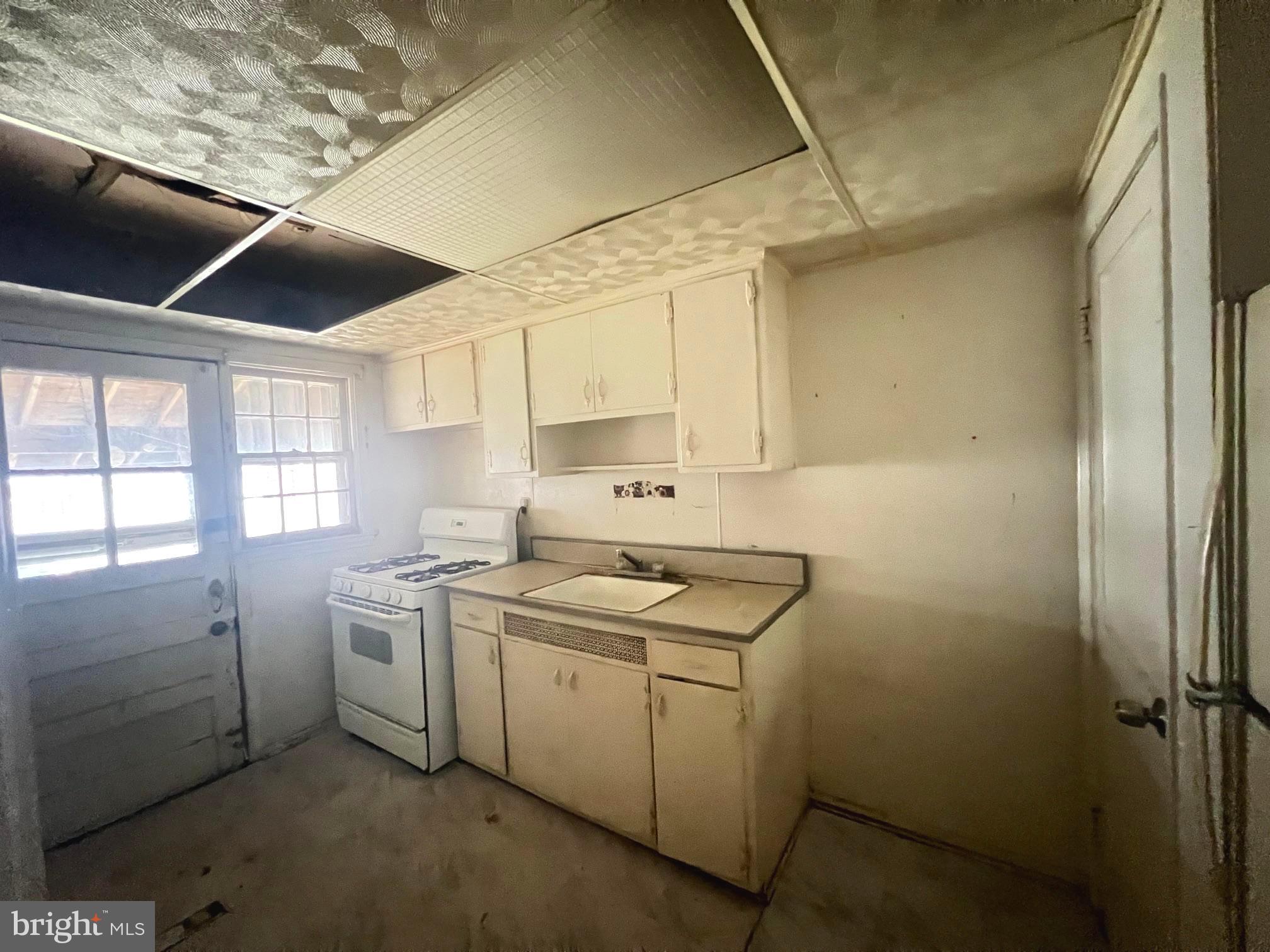 2165 Firethorn Road Baltimore, MD 21220 - Photo 7 of 10 a utility room with cabinets washer and dryer