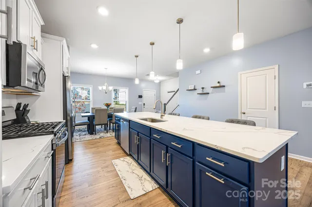 a large kitchen with kitchen island a sink a stove a center island a stove and a center island