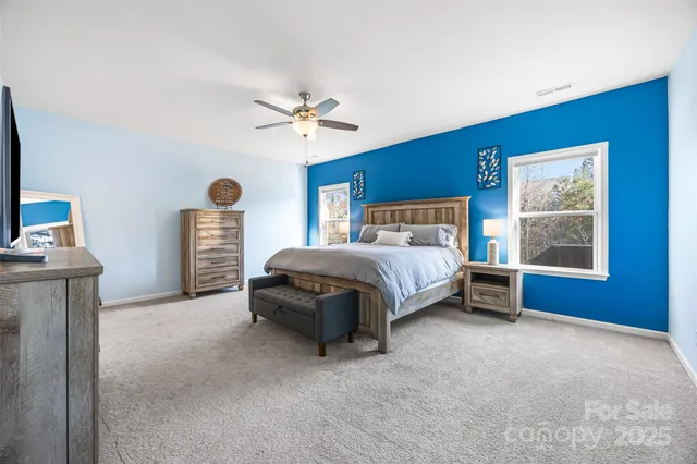 a bedroom with a bed and a ceiling fan