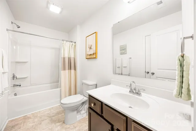 a bathroom with a sink toilet tub and shower