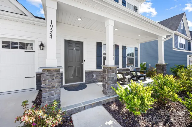 a lobby with furniture and flowers