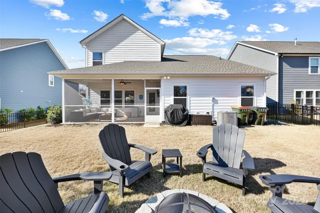 a view of a house with backyard and patio