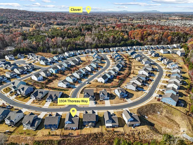 an aerial view of a swimming pool and an ocean