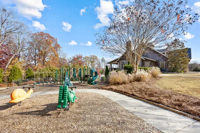 a row of palm trees in front of a house