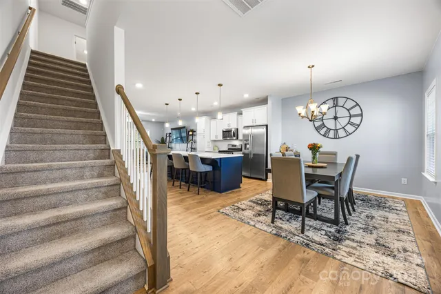 a view of a dining room and hall with furniture