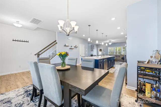 a view of a dining room with furniture and a chandelier