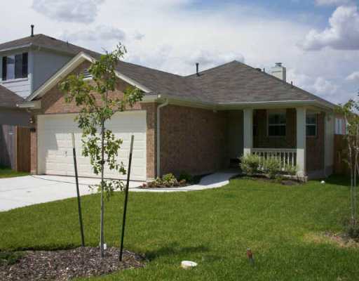 16013 Hamilton Point Circle Manor, TX 78653 - Photo 1 of 1 a front view of a house with a garden
