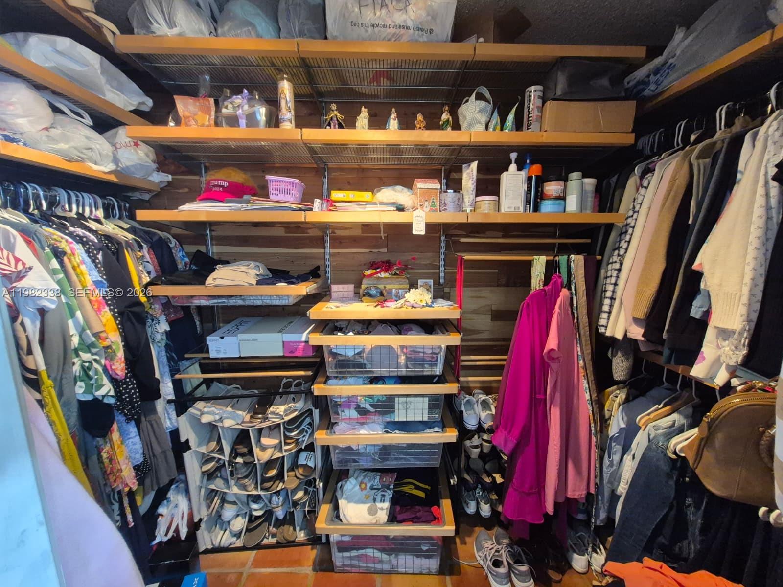 14530 Southwest 110th Street Miami, FL 33186 - Photo 19 of 45 a view of walk in closet with clothes and shoes