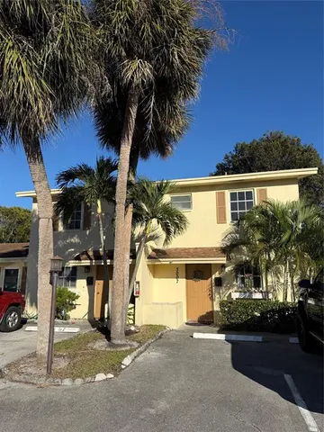 a front view of a house with a garden and a garage