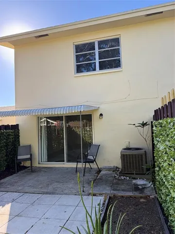 a view of a chairs and table in the backyard