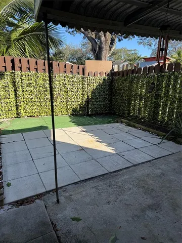 a view of a chairs and table in backyard