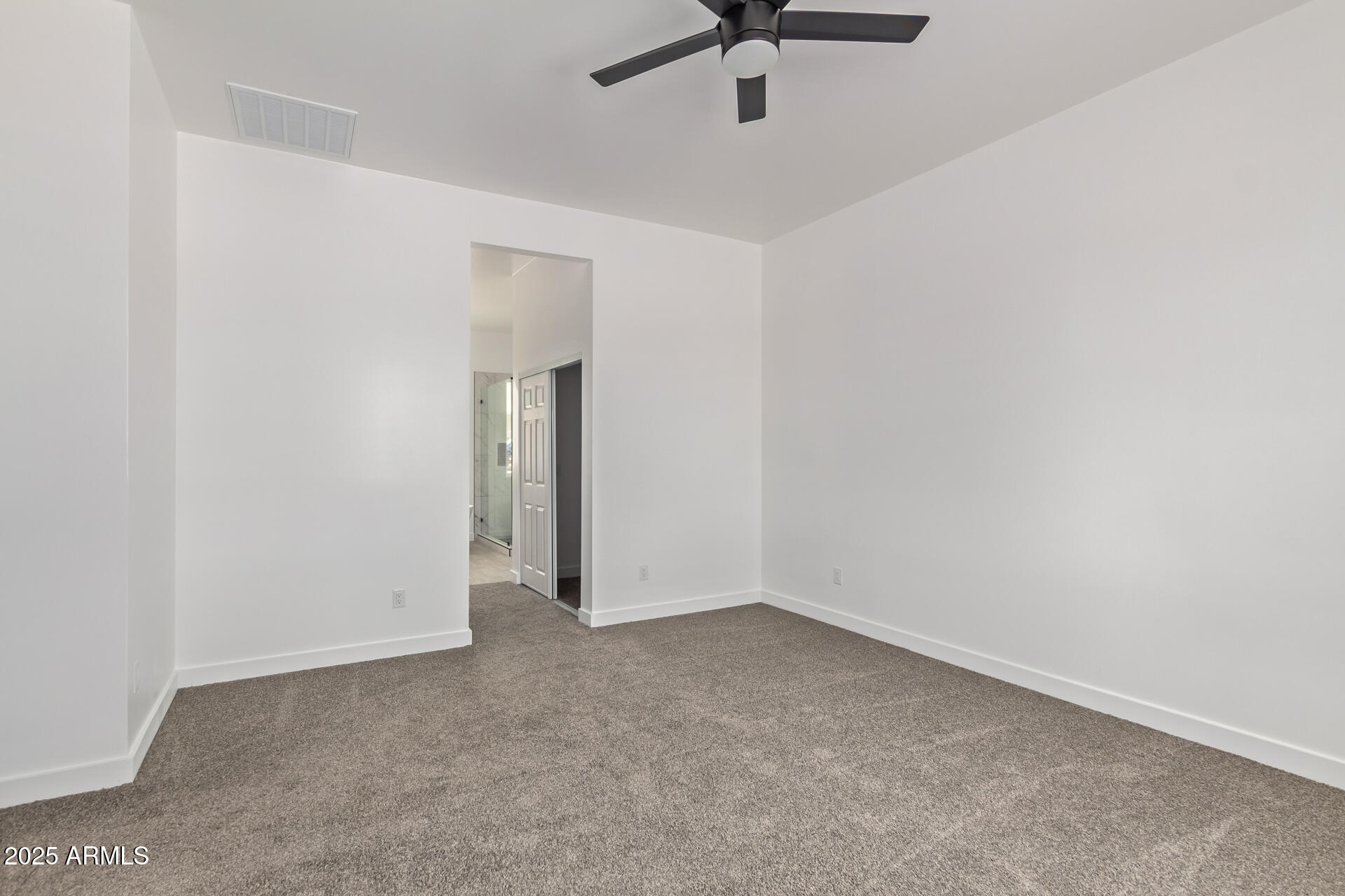 947 North Warner Drive Apache Junction, AZ 85120 - Photo 12 of 26 an empty room with a ceiling fan and carpet