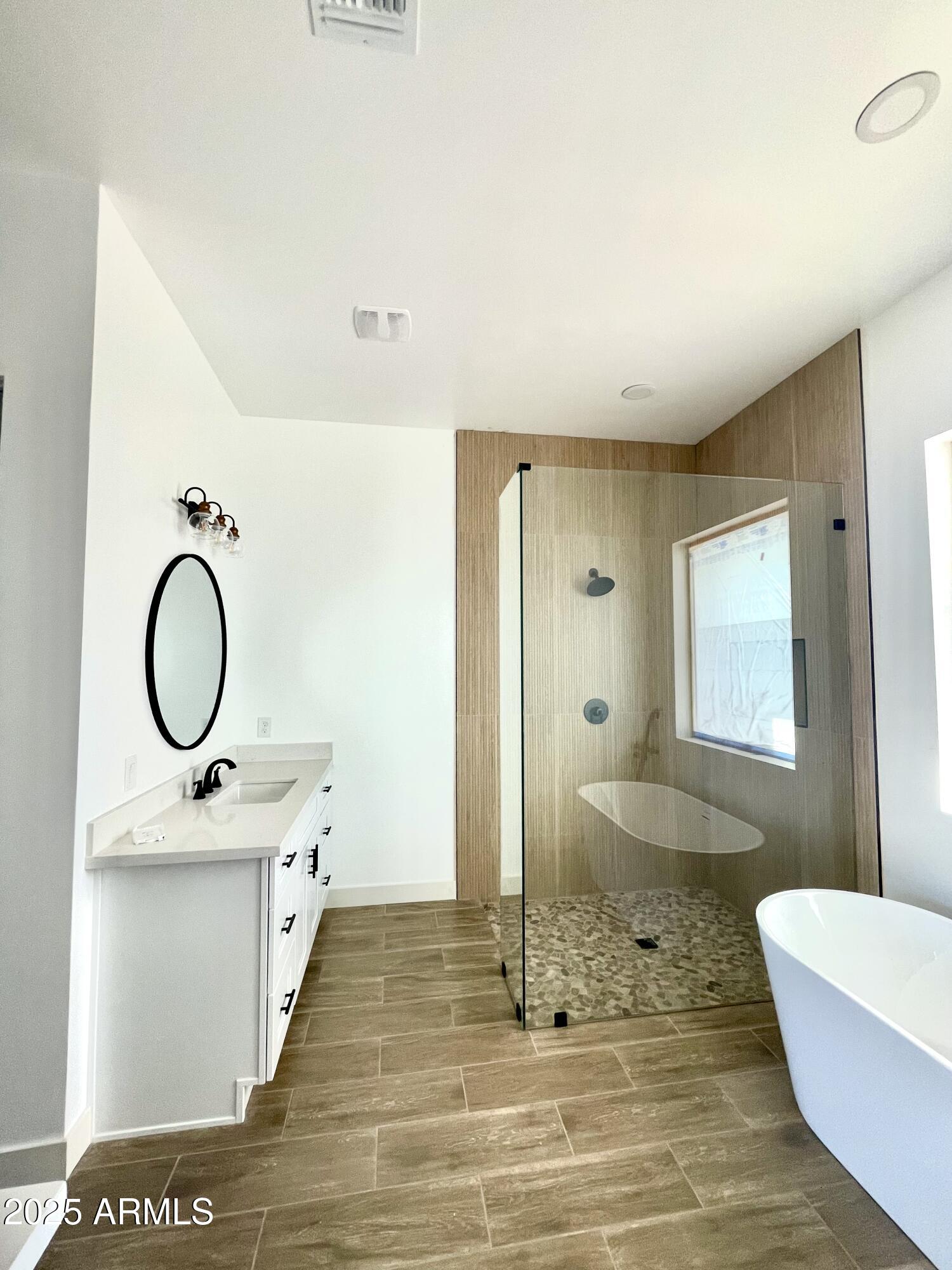 947 North Warner Drive Apache Junction, AZ 85120 - Photo 17 of 26 a bathroom with a sink a mirror and a shower