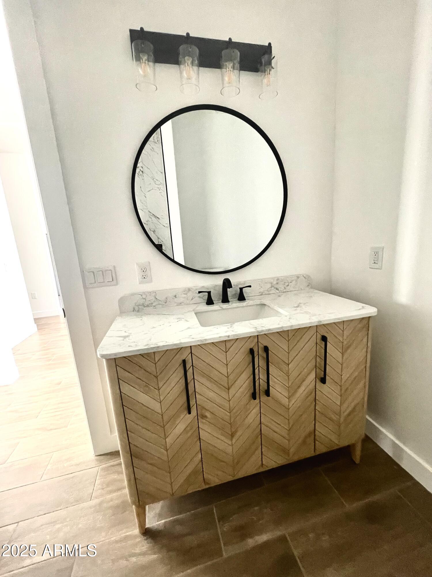 947 North Warner Drive Apache Junction, AZ 85120 - Photo 21 of 26 a bathroom with a granite countertop sink a mirror and a mirror