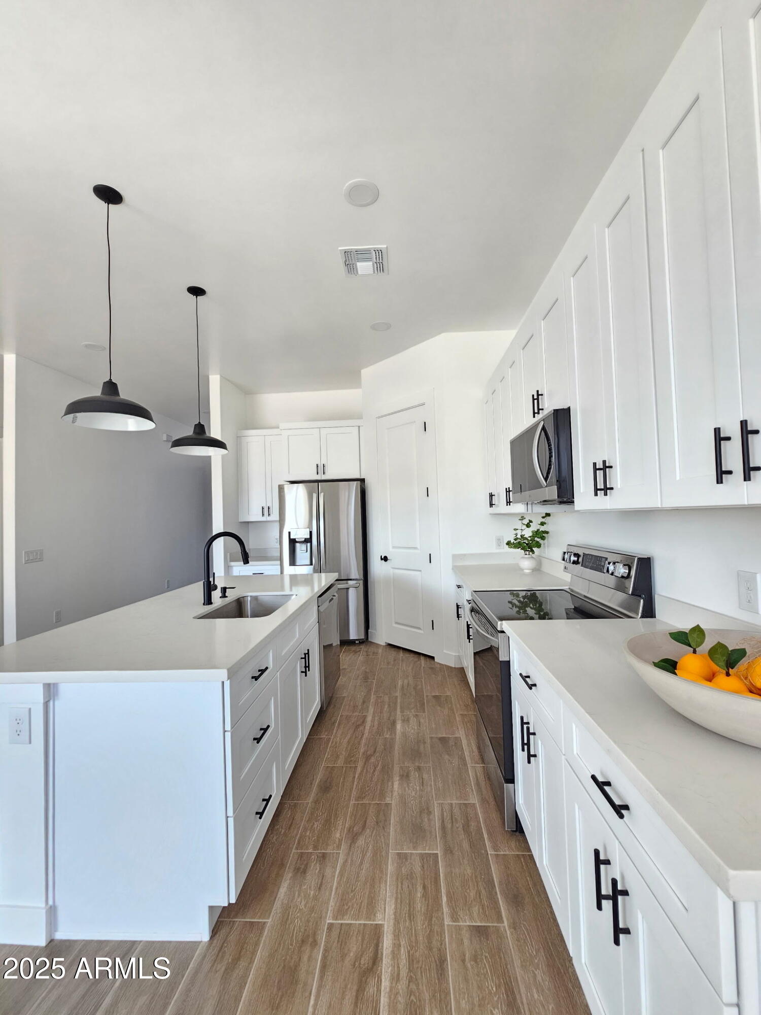947 North Warner Drive Apache Junction, AZ 85120 - Photo 5 of 26 a kitchen with a sink a stove and cabinets