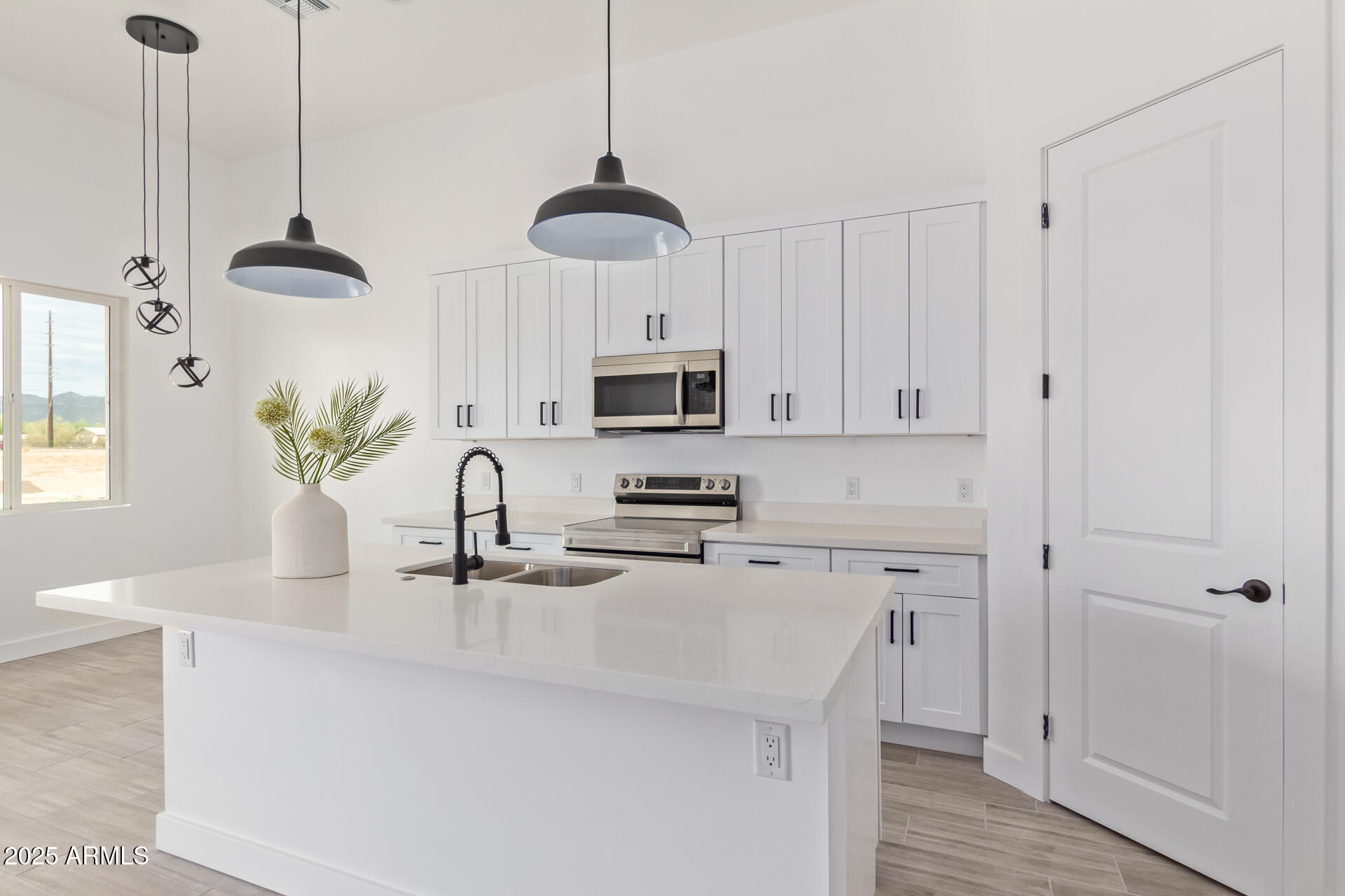 947 North Warner Drive Apache Junction, AZ 85120 - Photo 8 of 26 a kitchen with stainless steel appliances a sink a microwave a stove and a wooden floors
