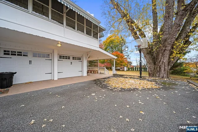 a front view of a house with porch and garden