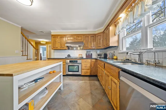 a kitchen with a sink and a stove top oven