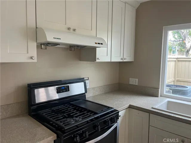 a kitchen with a sink and a washing machine