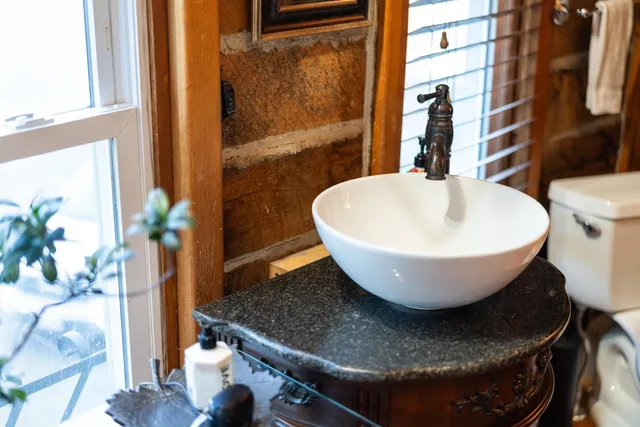 a kitchen with lots of clutter and stainless steel appliances
