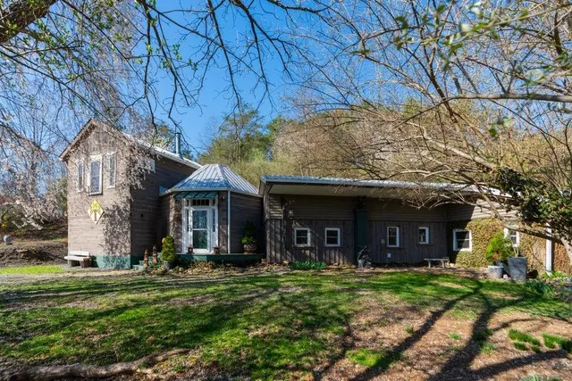 a view of a house with backyard garden and patio