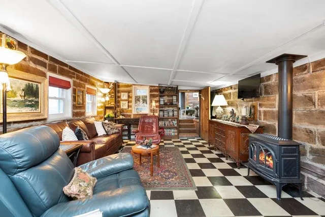 a living room with furniture and a floor to ceiling window