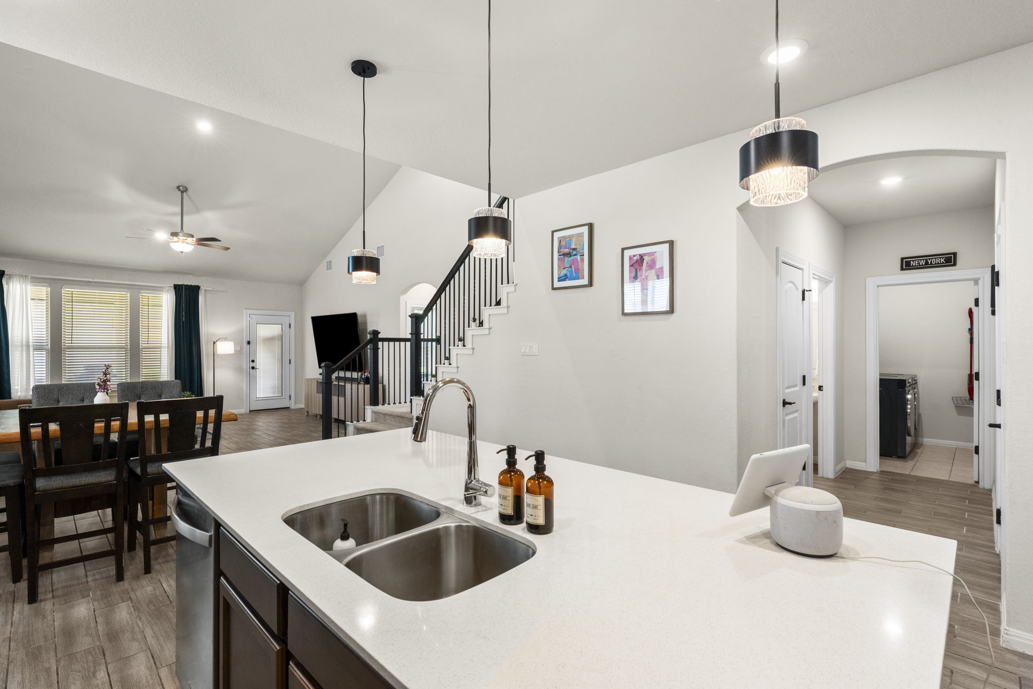 548 Purple Heart Drive Buda, TX 78610 - Photo 12 of 35 A well-appointed kitchen island with dual sinks anchors an inviting open-concept living space.