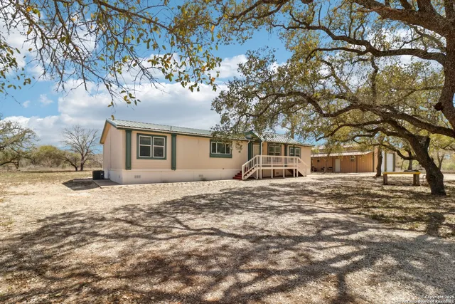 a kitchen with stainless steel appliances granite countertop a refrigerator sink and stove