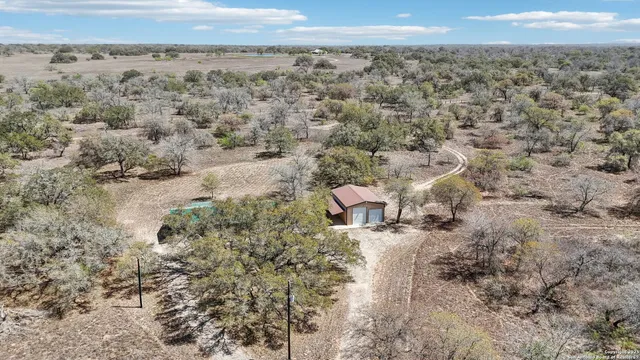an aerial view of a house with a yard