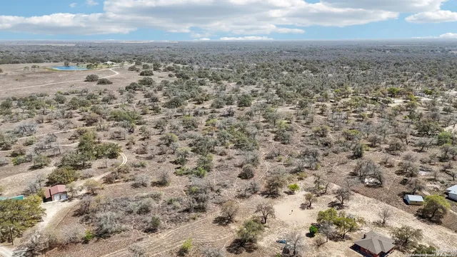an aerial view of house with yard and mountain in back