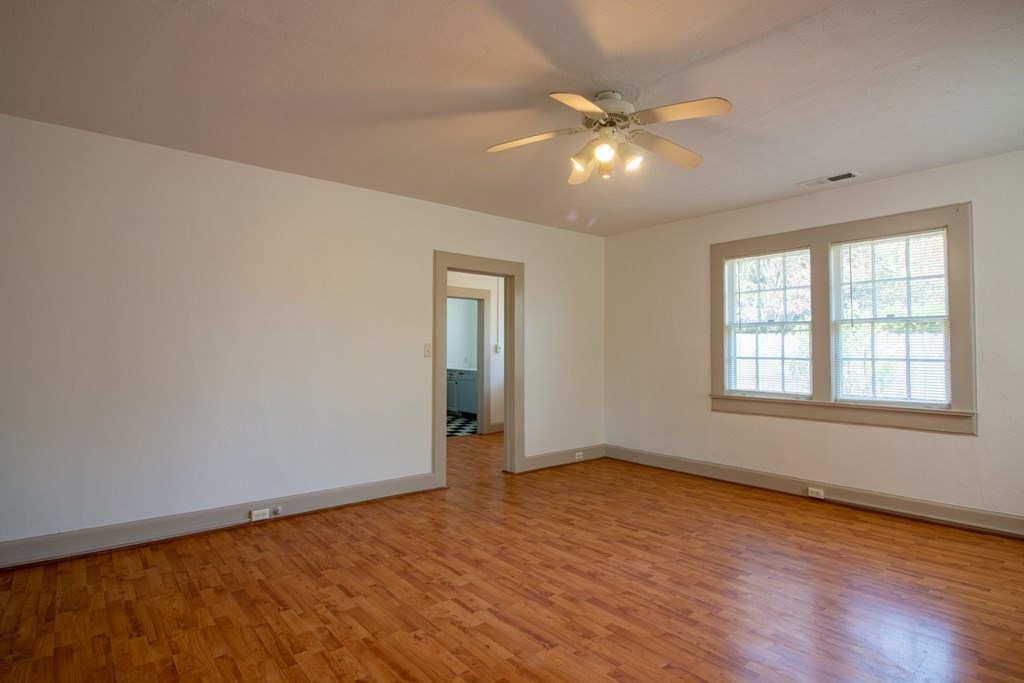 1505 1/2 16th Avenue Columbus, GA 31901 - Photo 2 of 10 a view of an empty room with wooden floor and a window