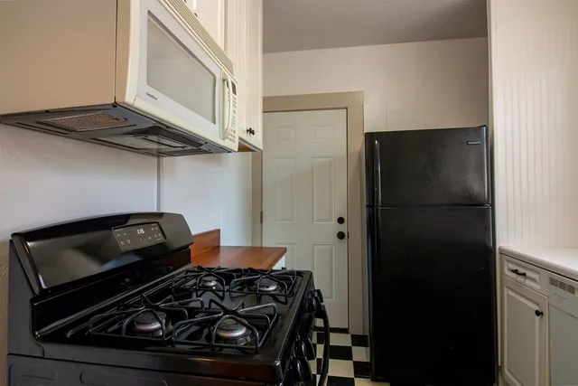 a kitchen with a stove and a refrigerator