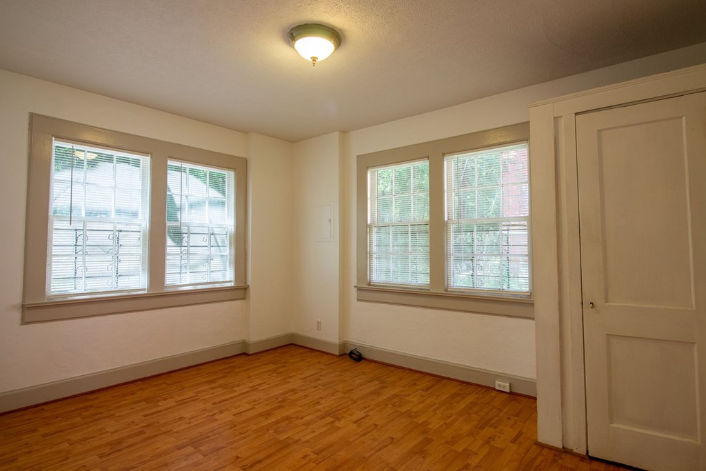1505 1/2 16th Avenue Columbus, GA 31901 - Photo 7 of 10 an empty room with wooden floor and windows