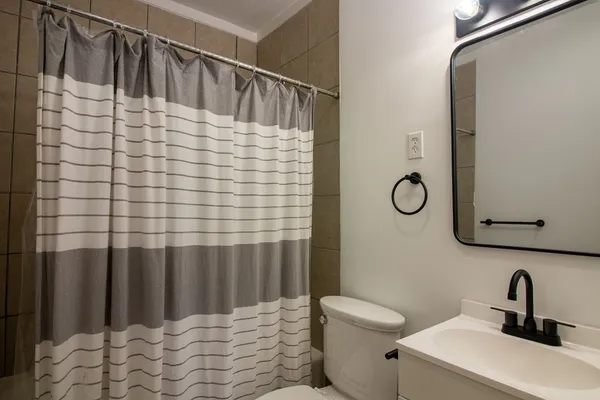 a bathroom with a sink toilet and shower