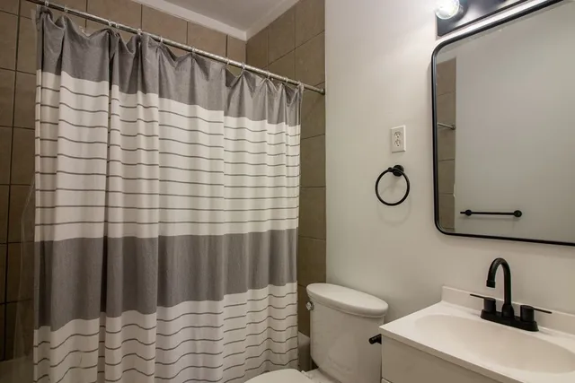 a bathroom with a sink toilet and shower