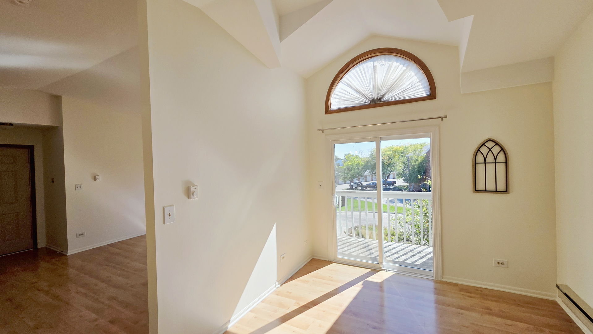 4302 West Shamrock Lane, Unit 3C McHenry, IL 60050 - Photo 11 of 20 a view of empty room with wooden floor and window