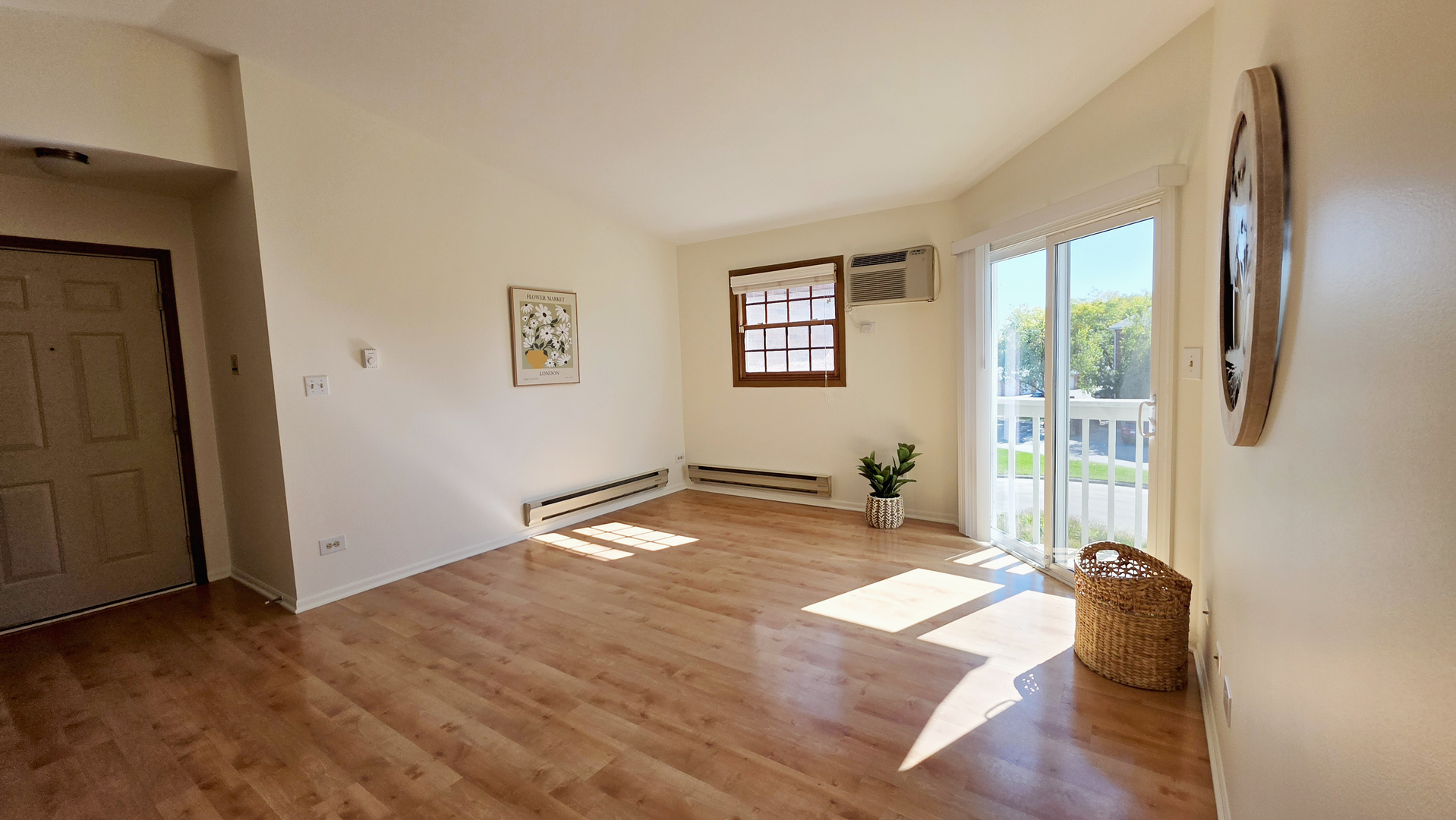 4302 West Shamrock Lane, Unit 3C McHenry, IL 60050 - Photo 13 of 20 an empty room with wooden floor and windows