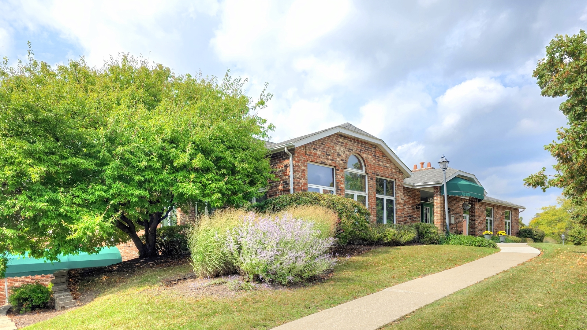 4302 West Shamrock Lane, Unit 3C McHenry, IL 60050 - Photo 18 of 20 a front view of a house with a garden