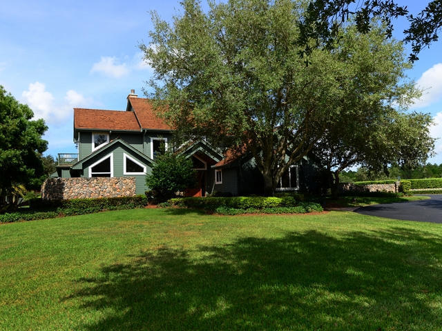 1100 Southeast Ranch Road South Jupiter, FL 33478 - Photo 3 of 23 Front View with trees