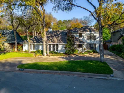 a front view of a house with swimming pool having outdoor seating