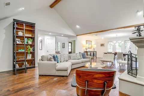 a living room with fireplace furniture and a wooden floor