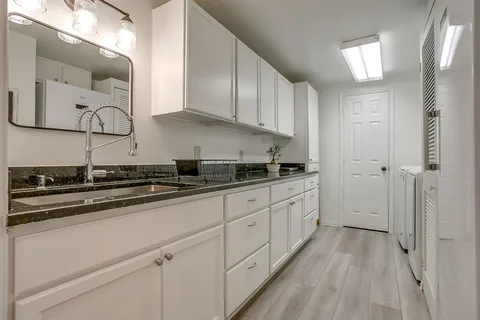 a kitchen with stainless steel appliances granite countertop a sink and cabinets