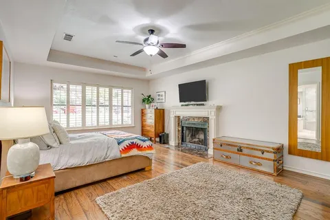 a bedroom with a bed dresser and a flat screen tv