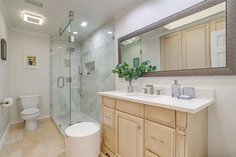 a bathroom with a sink toilet and shower