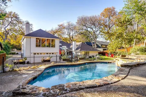 a swimming pool view with a outdoor seating