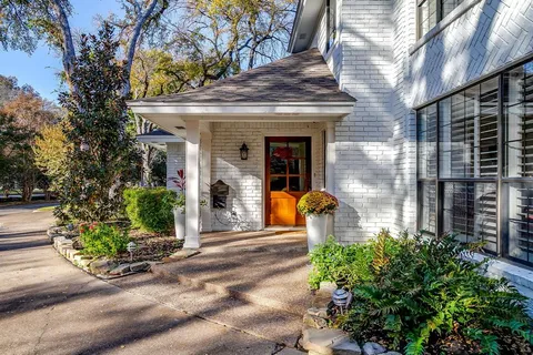 a view of a patio with table and chairs and potted plants