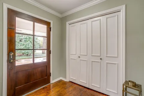 a view of a room with wooden floor and entryway